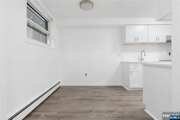 a view of cabinets and wooden floor
