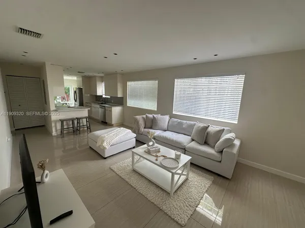 a living room with furniture and a large window