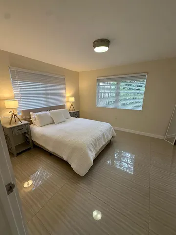 a bedroom with a bed and a night stand