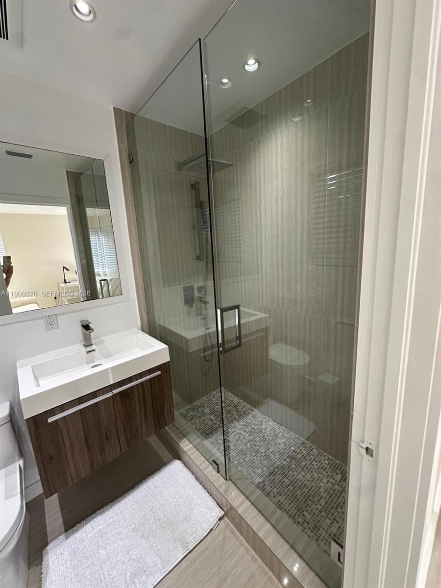9464 Abbott Avenue Surfside, FL 33154 - Photo 12 of 37 a bathroom with a sink a toilet and shower