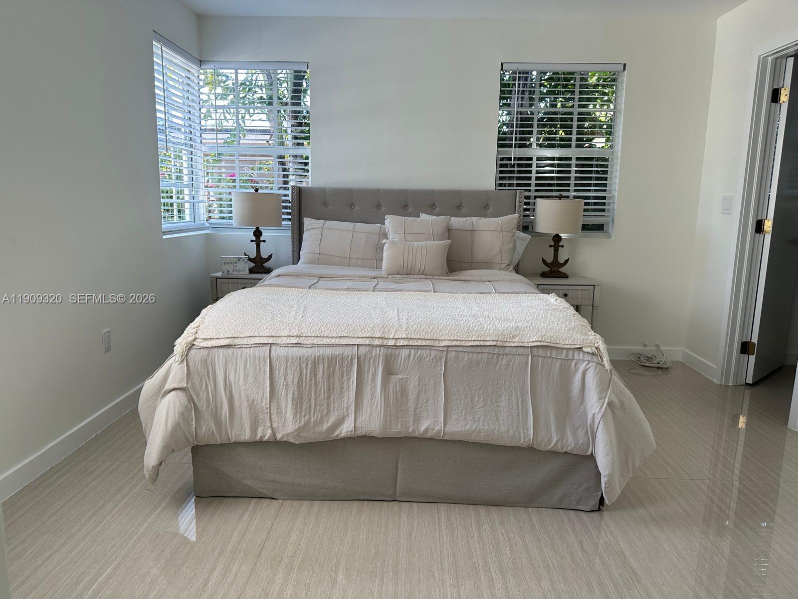 9464 Abbott Avenue Surfside, FL 33154 - Photo 16 of 37 a bedroom with a bed and window