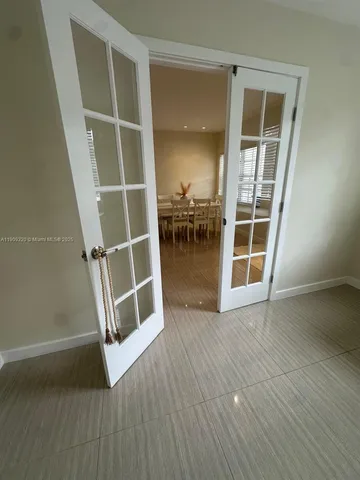 an empty room with wooden floor and door