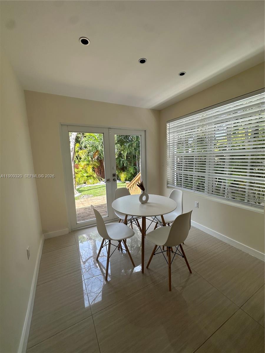 9464 Abbott Avenue Surfside, FL 33154 - Photo 23 of 37 a view of a dining room with furniture and a window