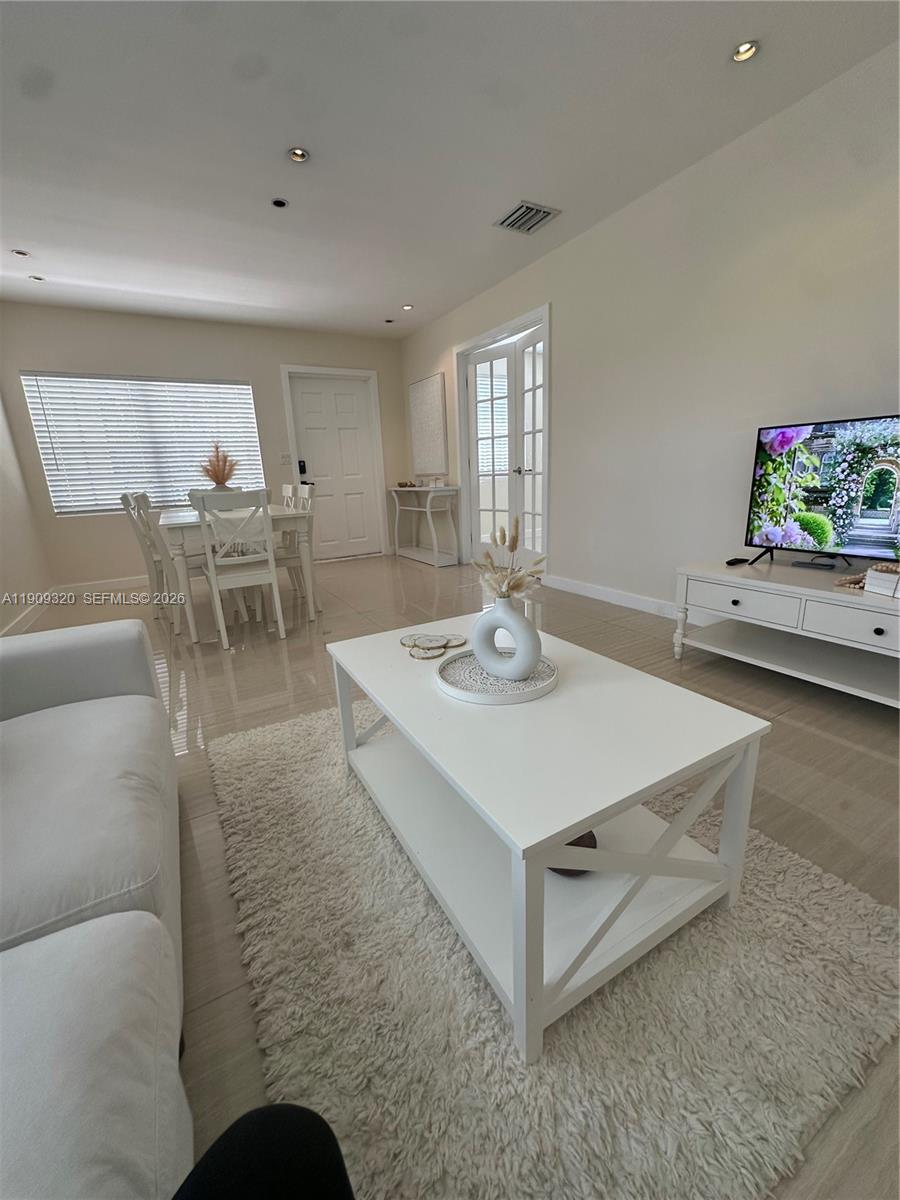 9464 Abbott Avenue Surfside, FL 33154 - Photo 35 of 37 a living room with furniture and a flat screen tv