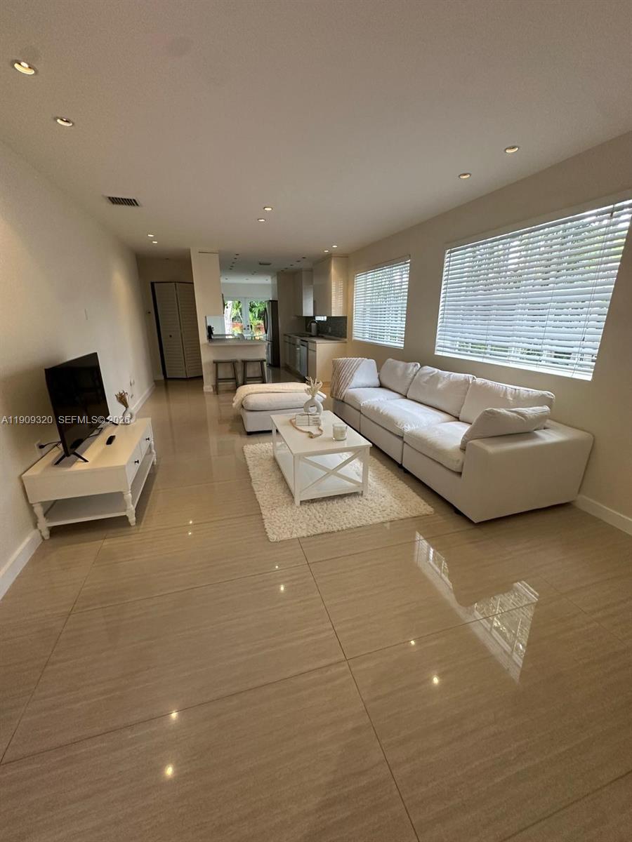 9464 Abbott Avenue Surfside, FL 33154 - Photo 5 of 37 a living room with furniture and a window