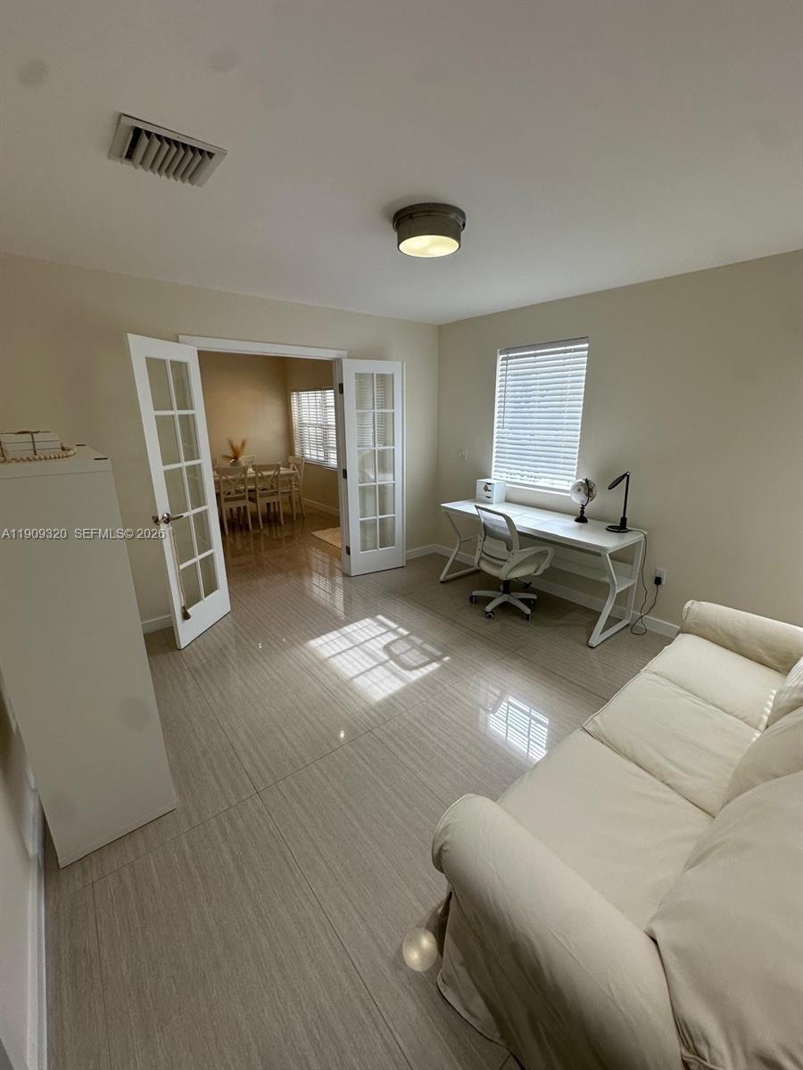 9464 Abbott Avenue Surfside, FL 33154 - Photo 6 of 37 a living room with furniture and a couch