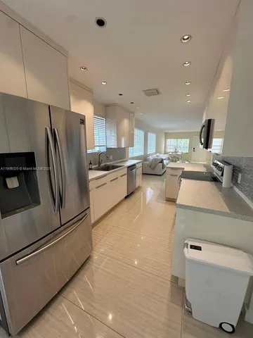 a kitchen with a refrigerator sink and stove