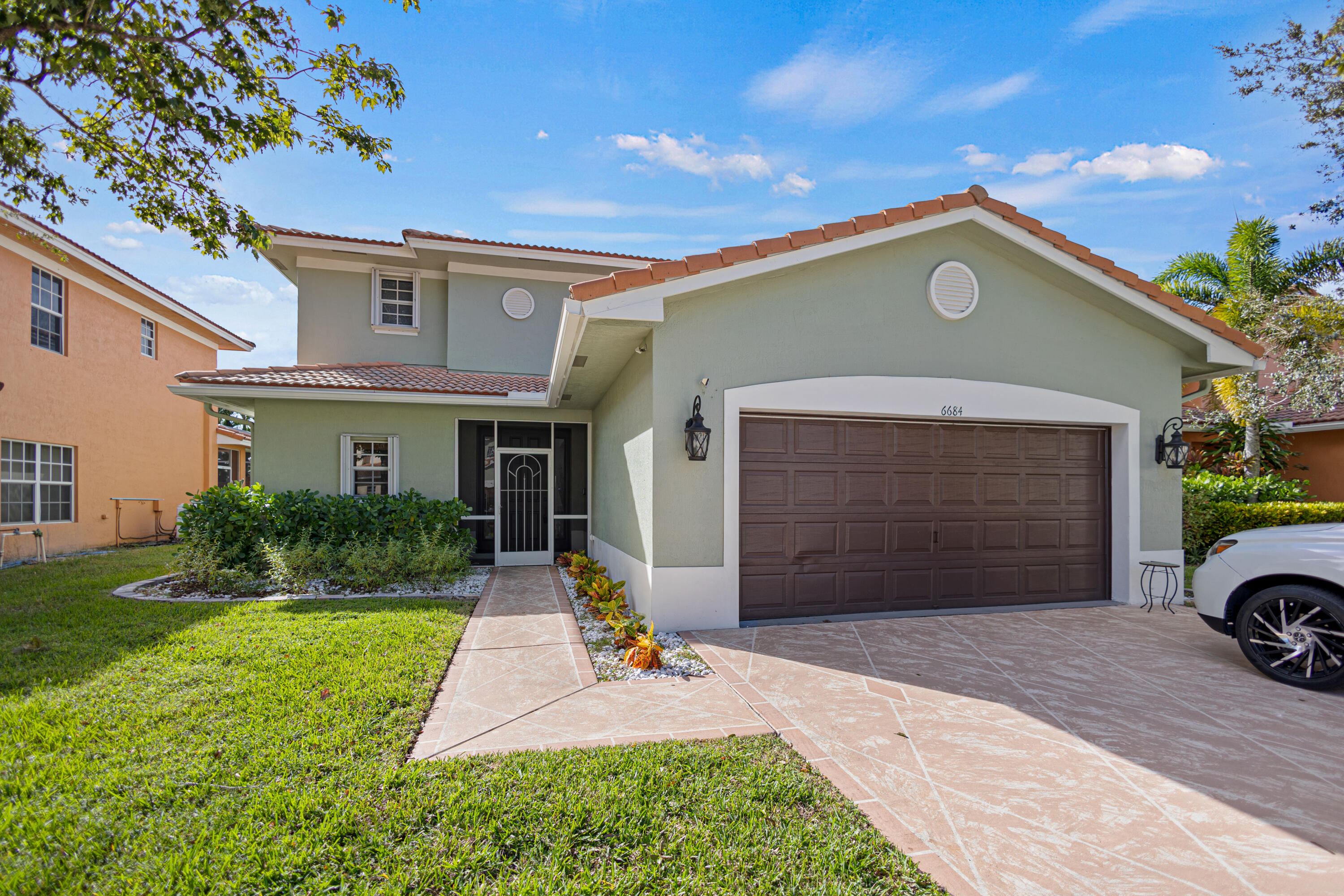 a front view of a house with a yard and garage