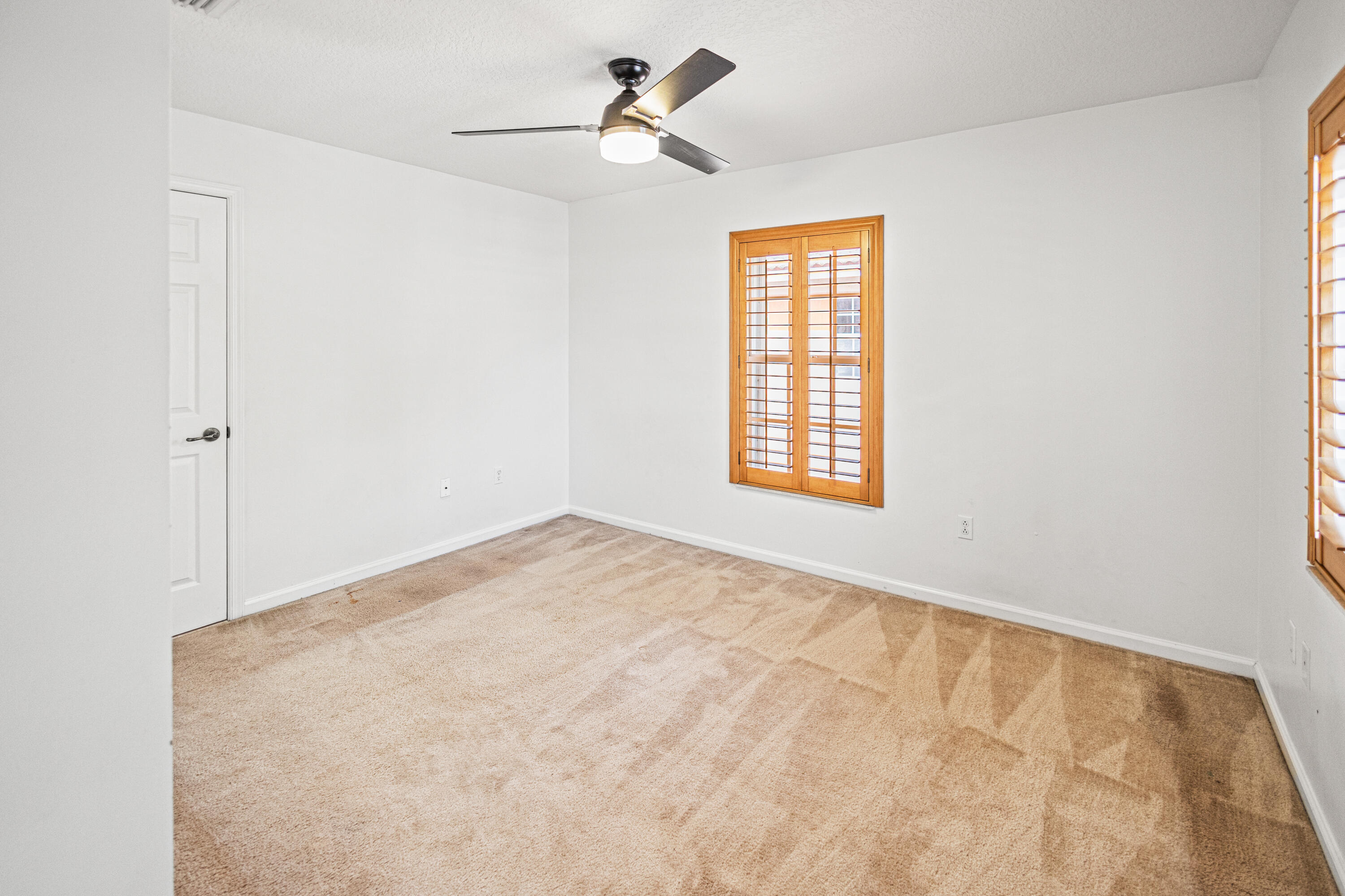 6684 Eagle Ridge Drive Greenacres, FL 33413 - Photo 12 of 27 a view of empty room with ceiling fan