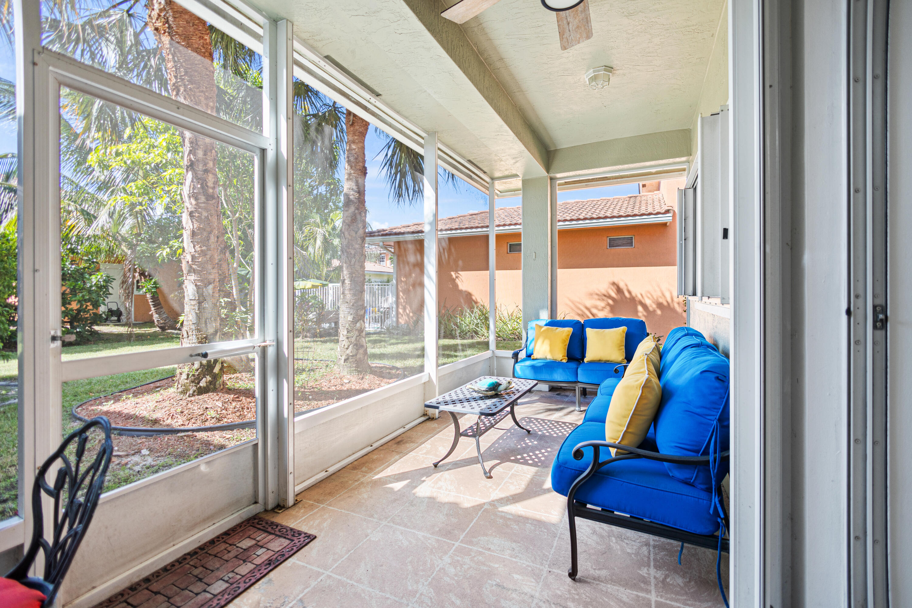 6684 Eagle Ridge Drive Greenacres, FL 33413 - Photo 17 of 27 a living room with furniture and a floor to ceiling window