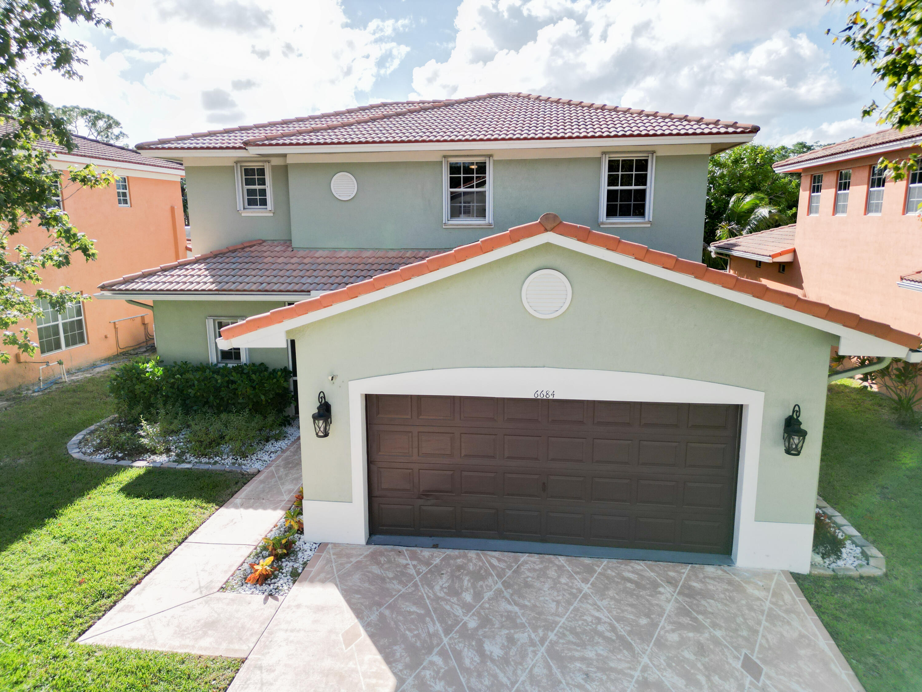6684 Eagle Ridge Drive Greenacres, FL 33413 - Photo 19 of 27 a front view of house with yard