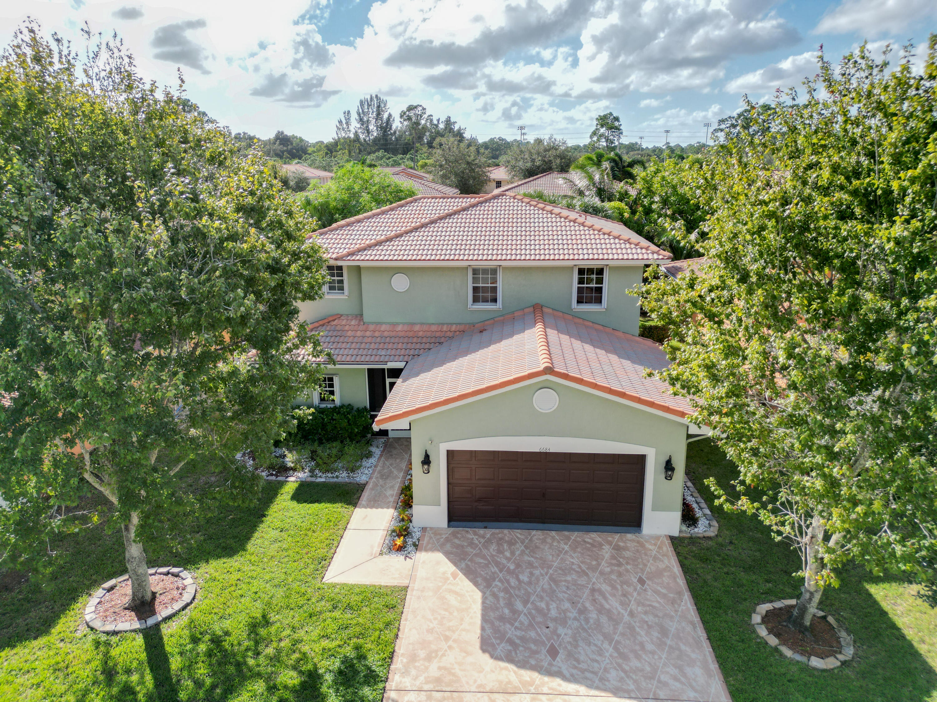 6684 Eagle Ridge Drive Greenacres, FL 33413 - Photo 20 of 27 a front view of a house with yard