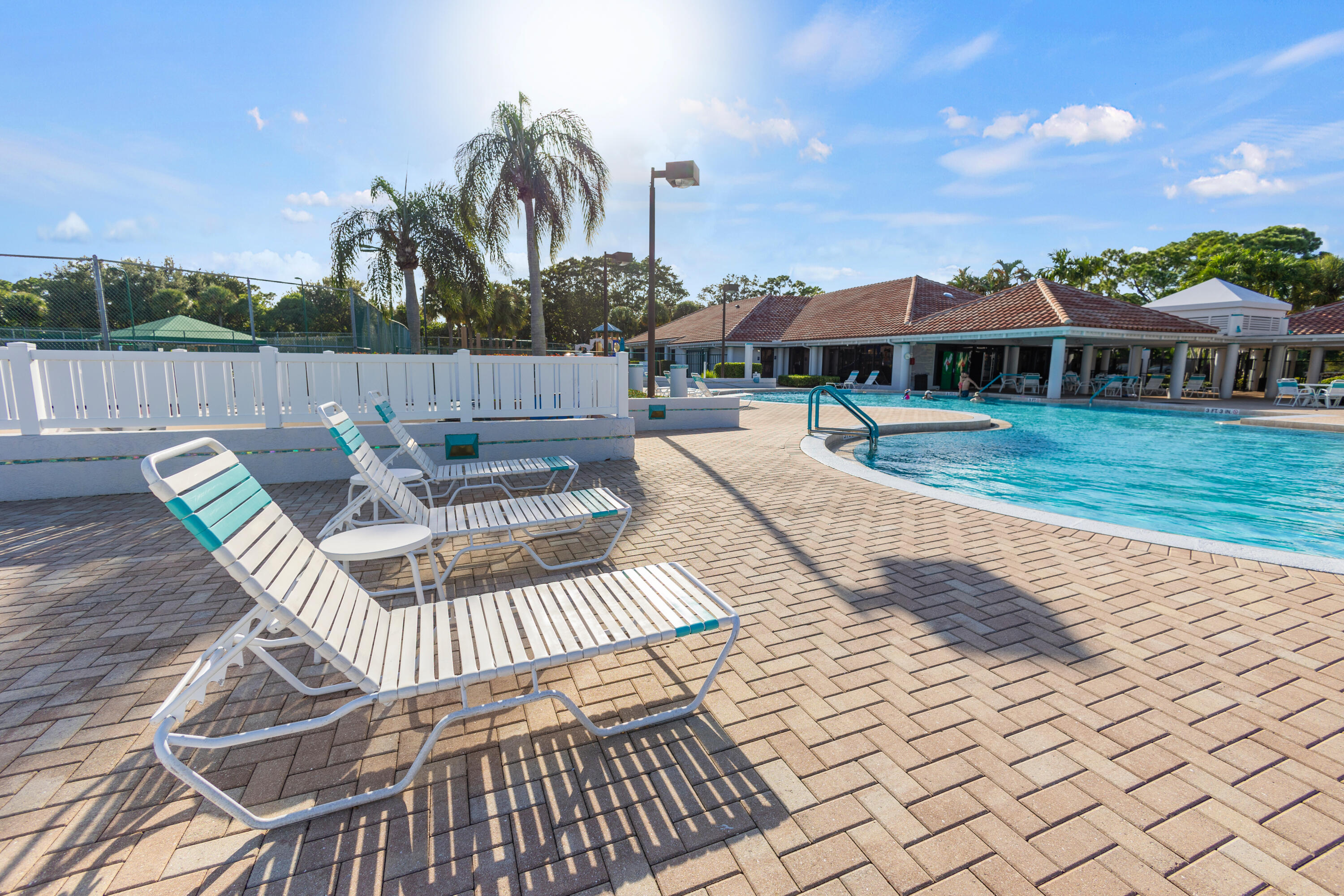 6684 Eagle Ridge Drive Greenacres, FL 33413 - Photo 23 of 27 a view of a patio with couches table and chairs with wooden floor and fence