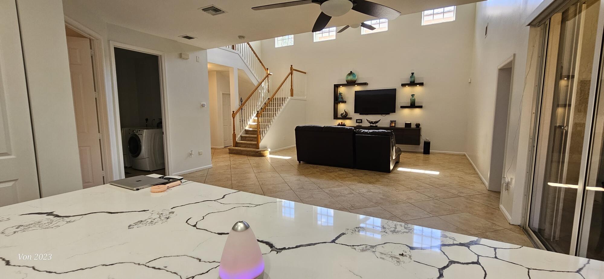 6684 Eagle Ridge Drive Greenacres, FL 33413 - Photo 6 of 27 a bedroom with a bed and flat screen tv