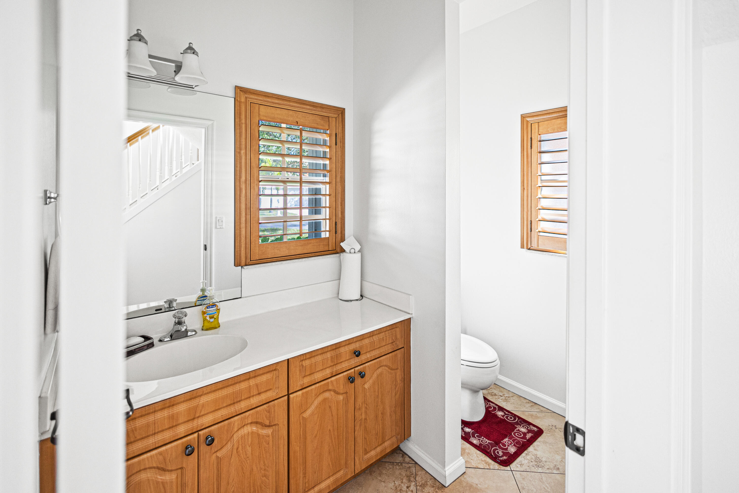 6684 Eagle Ridge Drive Greenacres, FL 33413 - Photo 9 of 27 a spacious bathroom with a sink a toilet and a window