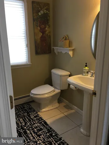 a bathroom with a toilet a sink and a window