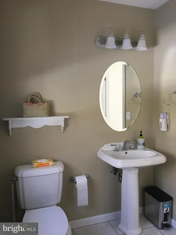 a bathroom with a sink mirror and toilet