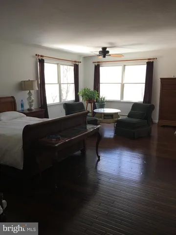 a living room with furniture window and wooden floor