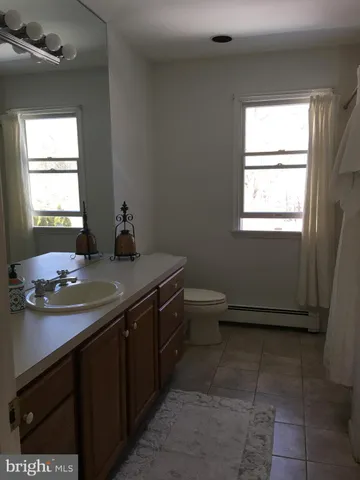a bathroom with a sink a vanity and a mirror