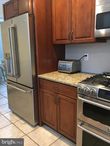 a kitchen with a stove and a refrigerator