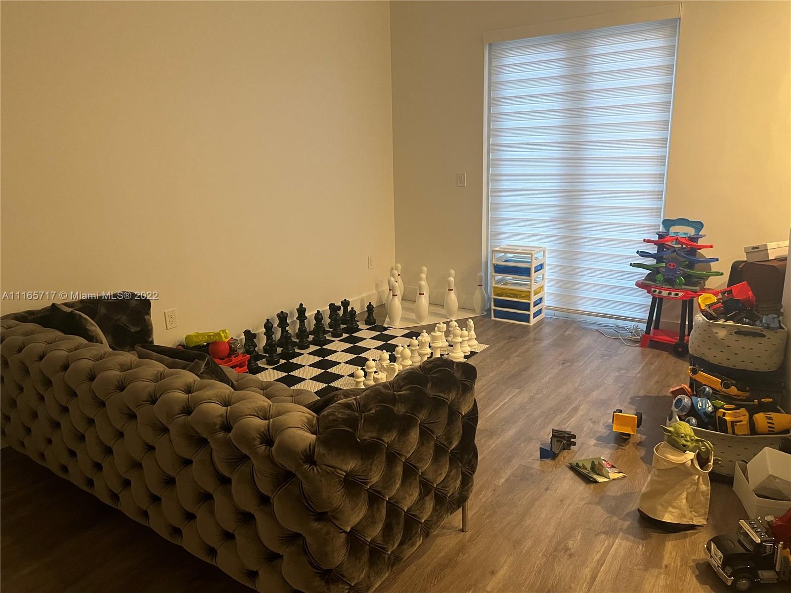 Doral Isles Doral, FL 33178 - Photo 12 of 37 a living room with furniture and a floor to ceiling window