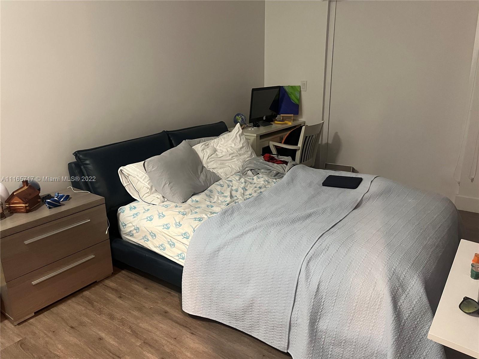 Doral Isles Doral, FL 33178 - Photo 16 of 37 a bedroom with a bed and a flat screen tv