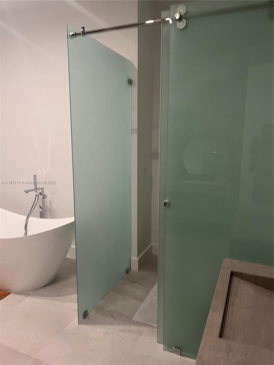 Doral Isles Doral, FL 33178 - Photo 19 of 37 a bathroom with a bathtub and shower