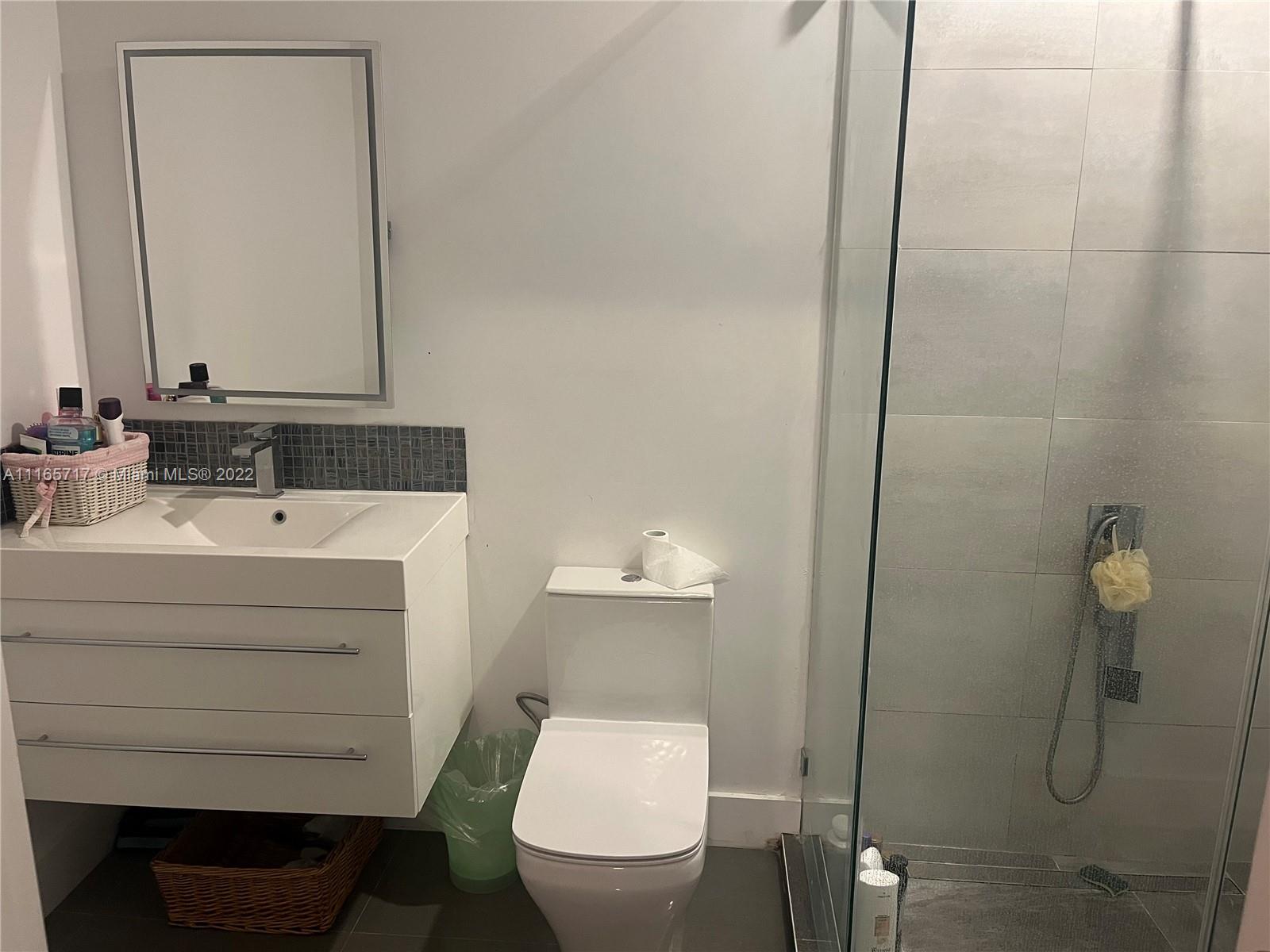 Doral Isles Doral, FL 33178 - Photo 20 of 37 a bathroom with a sink a toilet and a mirror