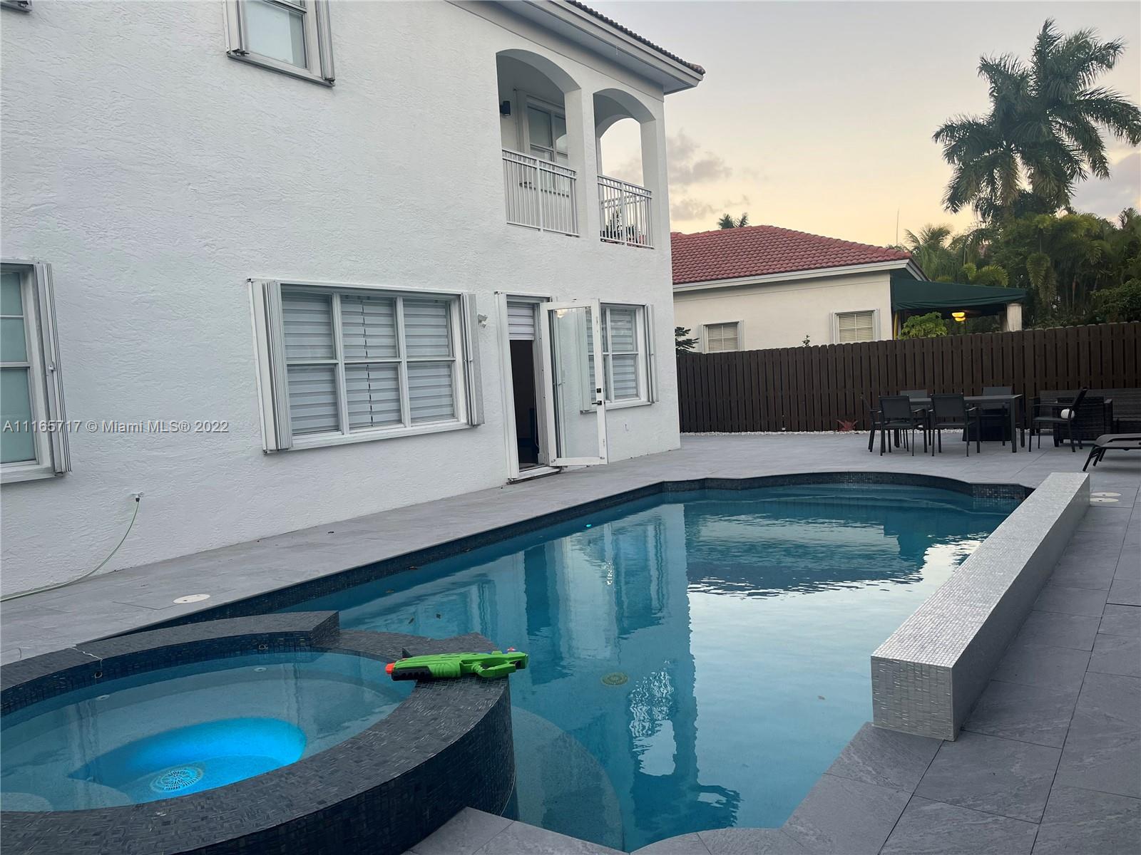 Doral Isles Doral, FL 33178 - Photo 28 of 37 a view of a house with pool and sitting area
