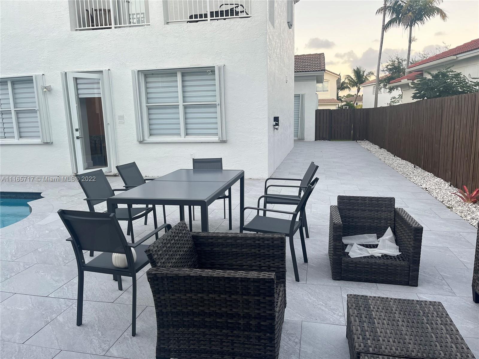 Doral Isles Doral, FL 33178 - Photo 30 of 37 a balcony with table and chairs