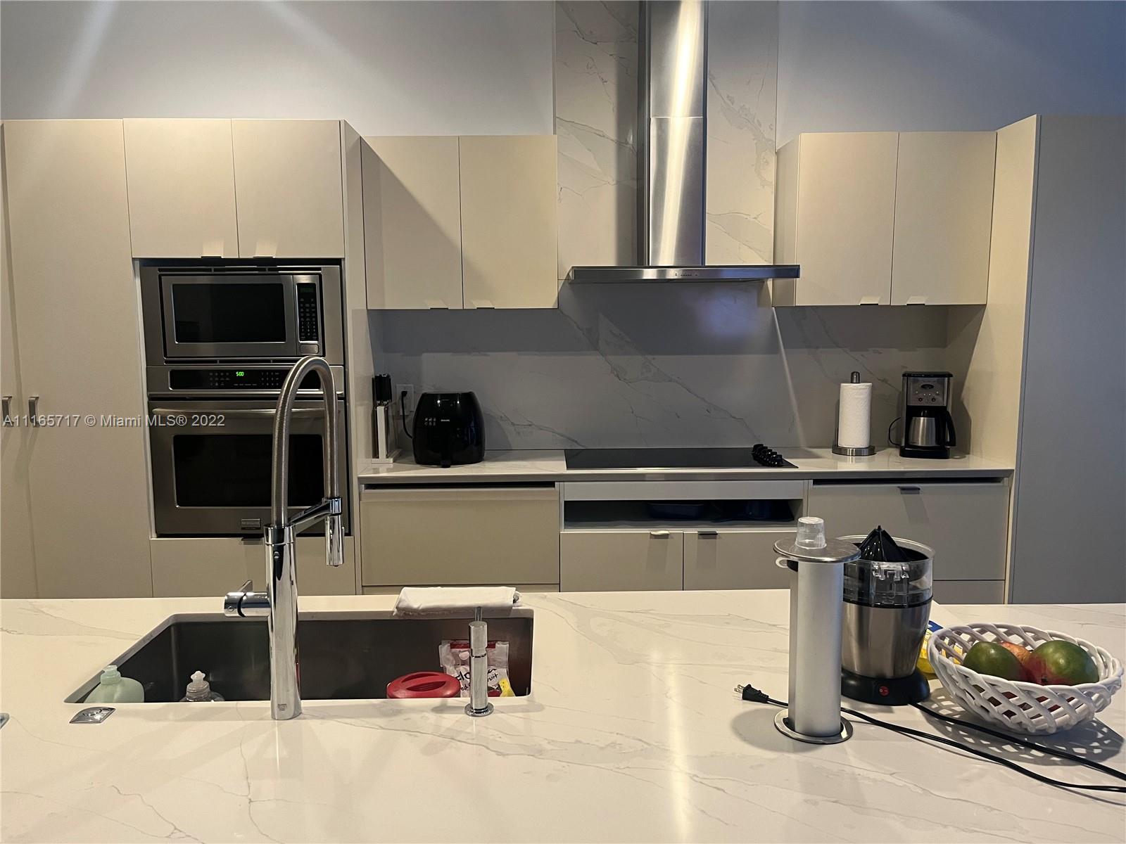 Doral Isles Doral, FL 33178 - Photo 3 of 37 a kitchen with a sink and a stove top oven