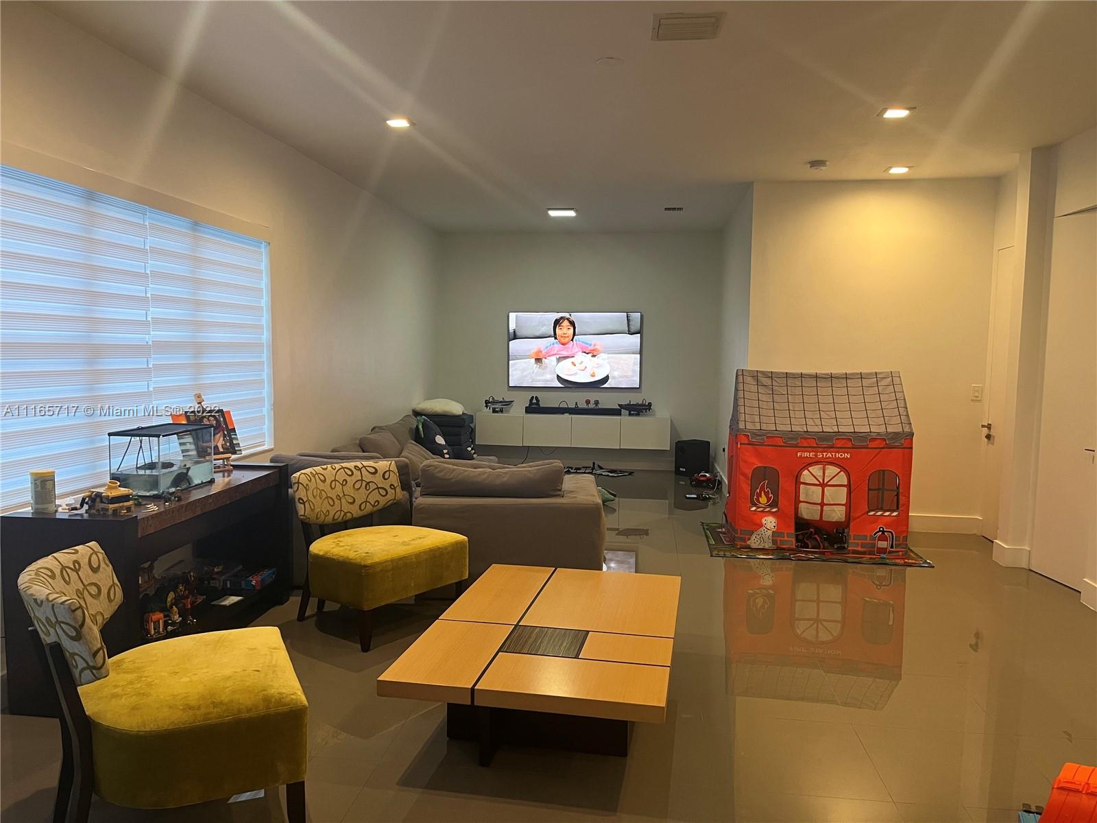 Doral Isles Doral, FL 33178 - Photo 6 of 37 a living room with furniture and a flat screen tv