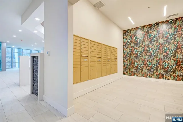 a bedroom with a bed and a night stand