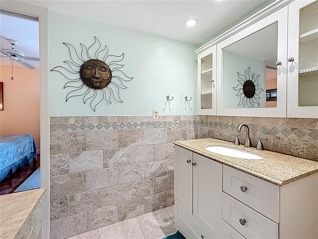 230 Medallion Boulevard, Unit G Madeira Beach, FL 33708 - Photo 26 of 38 a bathroom with a sink and a mirror