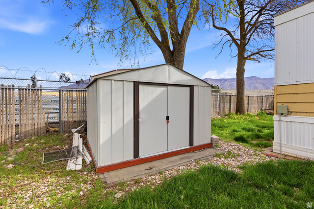 2491 Highway 89, Unit 123 Pleasant View, UT 84404 - Photo 16 of 16 View of shed featuring a fenced backyard and a mountain view
