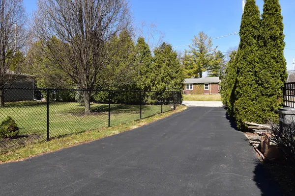 a front view of house with yard outdoor seating and barbeque oven