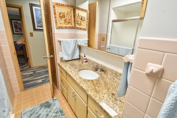 a bathroom with a toilet a sink and a mirror