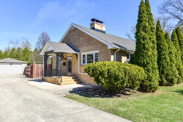 a view of a house with backyard and trees