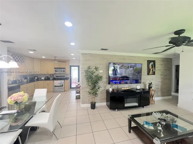a living room with furniture and kitchen view