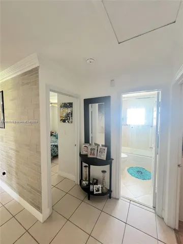 a view of a hallway and a livingroom with wooden floor