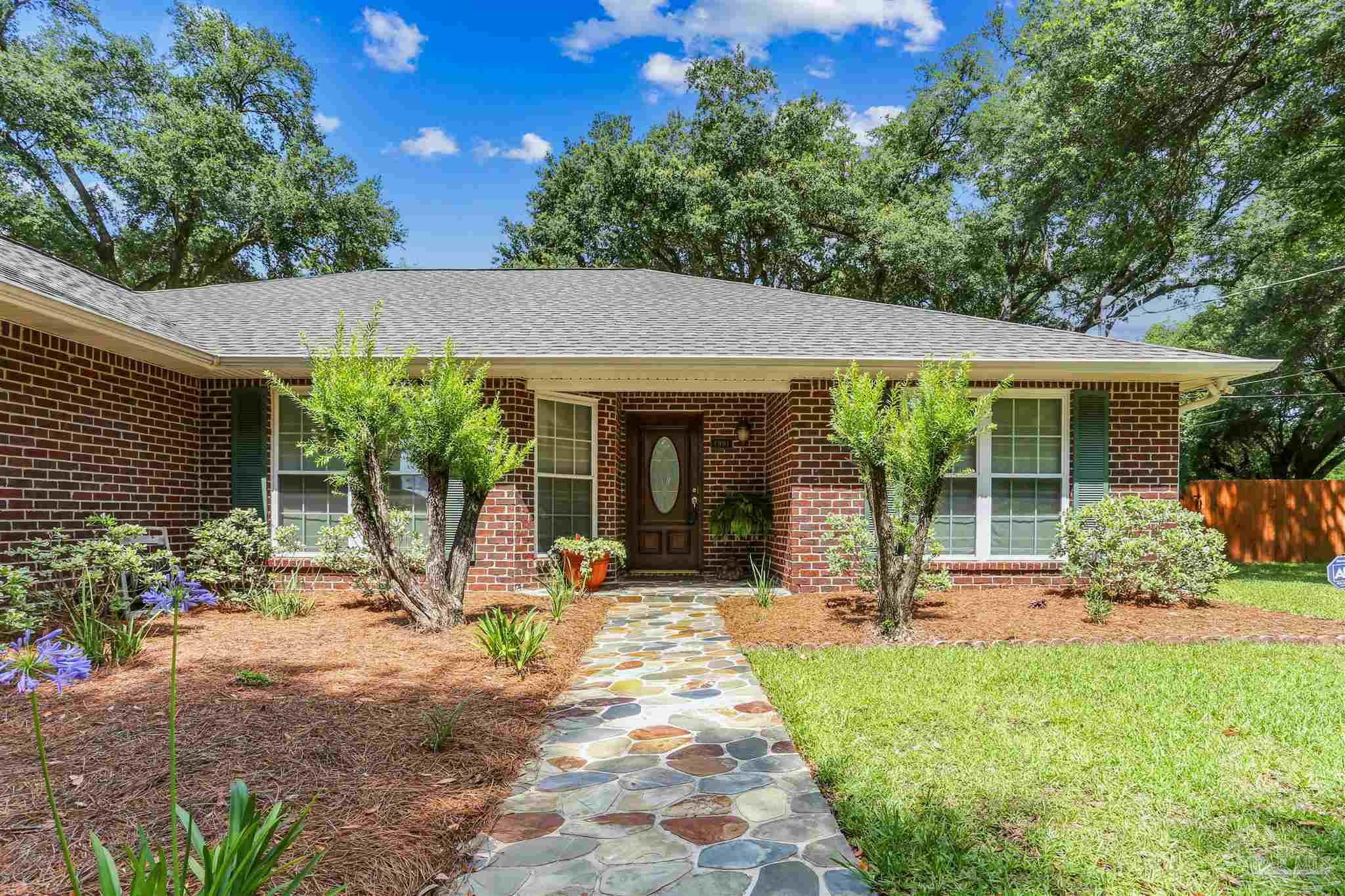 a view of a house with sitting area and garden