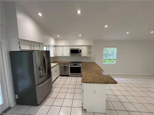 a view of empty room with window and hardwood floor