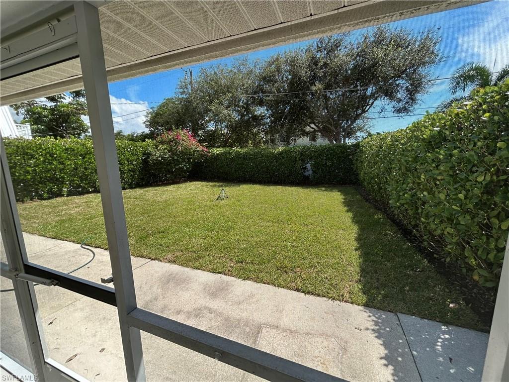 772 100th Avenue North Naples, FL 34108 - Photo 13 of 25 a view of a floor to ceiling window next to yard