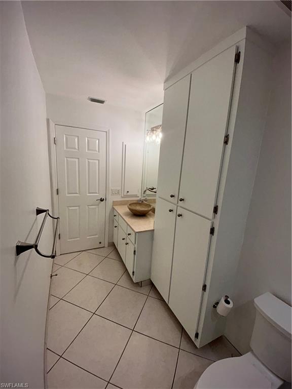772 100th Avenue North Naples, FL 34108 - Photo 17 of 25 a bathroom with a sink a toilet and a mirror