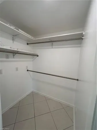 a view of empty room with window and hardwood floor