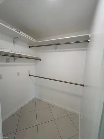a view of empty room with window and hardwood floor