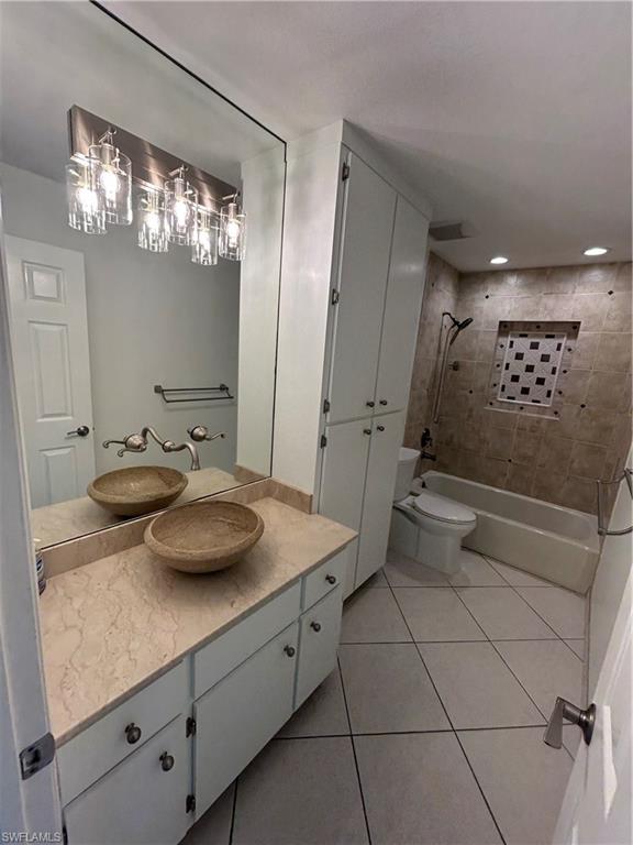 772 100th Avenue North Naples, FL 34108 - Photo 3 of 25 a bathroom with a sink a toilet and a mirror