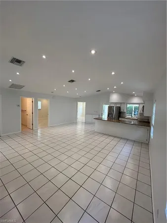 a kitchen with stainless steel appliances granite countertop a refrigerator a oven and a sink