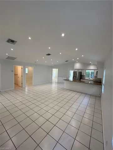 a kitchen with stainless steel appliances granite countertop a refrigerator a oven and a sink