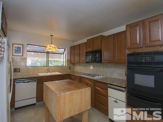 15300 Pyramid Way Reno, NV 89510 - Photo 9 of 25 a kitchen that has a sink and a stove top oven